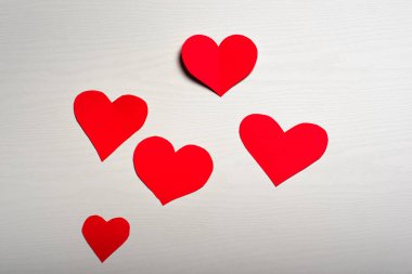 Ahşap beyaz arka plan kırmızı kalpler ile. Sevgililer günü kavramı.