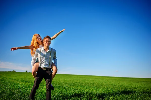 Smiling Man Holding His Back Happy Woman Who Pulls Out — Stock Photo, Image