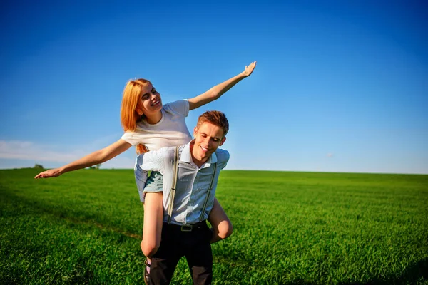 Smiling Man Holding His Back Happy Woman Who Pulls Out — Stock Photo, Image