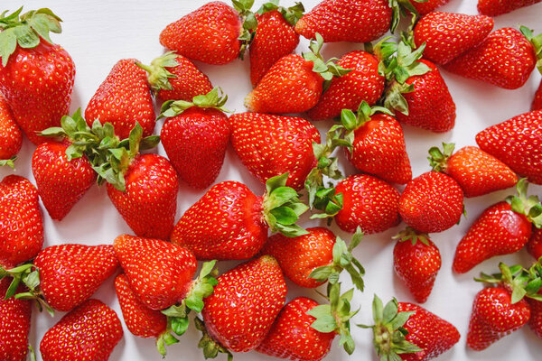Fresh strawberry. Strawberries on white concrete background. Harvest of organic local strawberries.