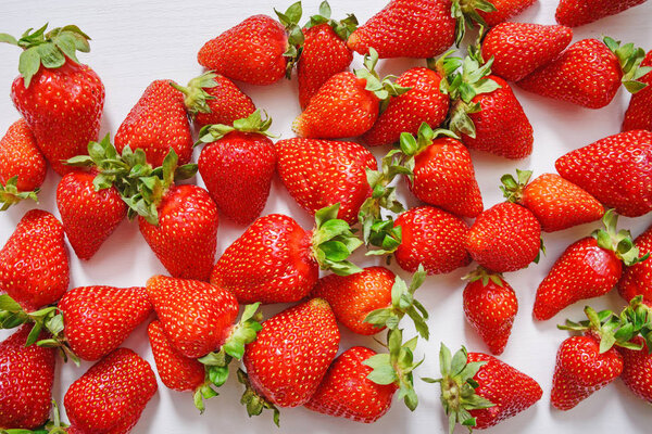 Fresh strawberry. Strawberries on white concrete background. Harvest of organic local strawberries.