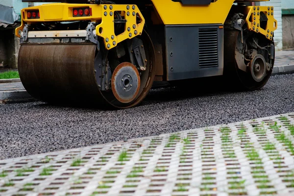 Background of asphalt roller that stack and press hot asphalt. Road repair machine.