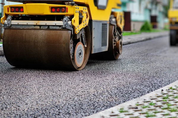 Background of asphalt roller that stack and press hot asphalt. Road repair machine.