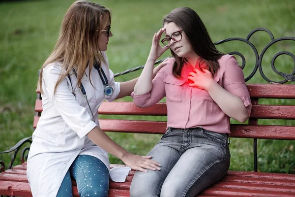 bakan doktor veya Hemşire Genç hastaya açık havada, bir bankta oturan alarak tutun konuşma.