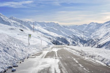 Dağ asfalt yol ile kar yan ve dağ gökyüzü arka plan üzerinde bir çok