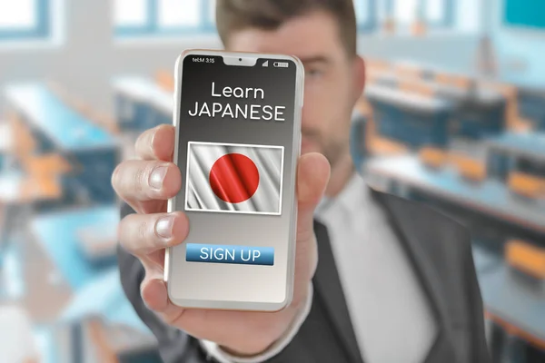 Online concept learn Japanese language with a person showing e-learning app on mobile phone with the flag of Japan
