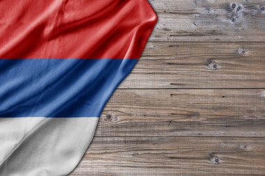 Wooden pattern old nature table board with Serbian Republic flag