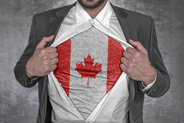 Business man rips open his shirt to show t-shirt with flag of Canada 
