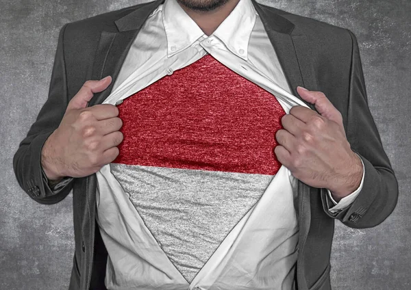 stock image Business man show t-shirt flag of Indonesia rips open his shirt 