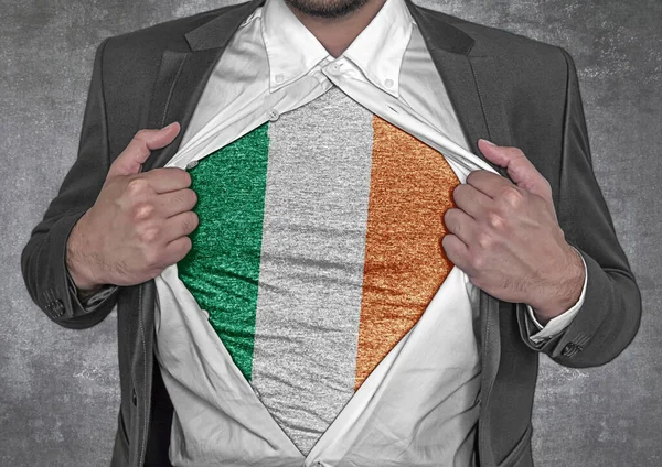 Business man show t-shirt flag of Ireland rips open his shirt