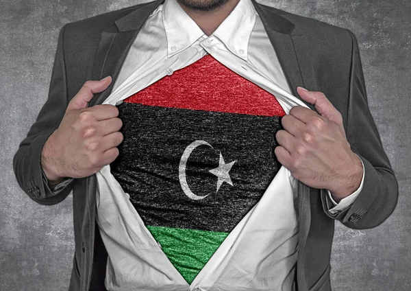 Business man show t-shirt flag of Libya rips open his shirt