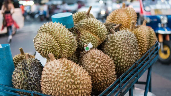 Durians in the Asian market close-up. Sale of fruits of durian on a cart