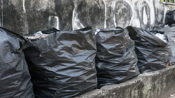 black trash bags. Garbage problem in Asia