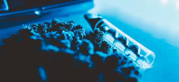 smoking accessories for marijuana close-up. Glass blunt for smoking cannabis 