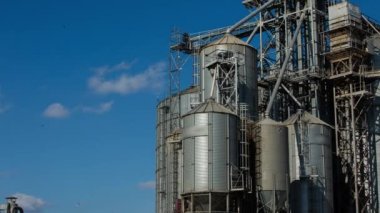 Gökyüzünde bulutlar hareketiyle Timelapse. Modern tahıl terminal. Asansör metal tankları. Tahıl kurutma Kompleksi inşaatı. Ticari tahıl ya da tohum silolar. Tarım hasat için çelik depolama.
