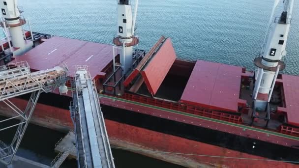 Top view panorama of opening cargo ship holds at silo terminal in seaport. Cereals bulk transshipment to vessel. Transportation of agricultural products. — Stock Video