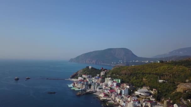 Drohnenpanorama-Aufnahmen von farbenfrohen Stadtlandschaften auf den Bergen über dem Meer, Europa, dichten mehrstöckigen Gebäuden am Meer im Resort. Krim, Utellings, Schwarzes Meer. — Stockvideo