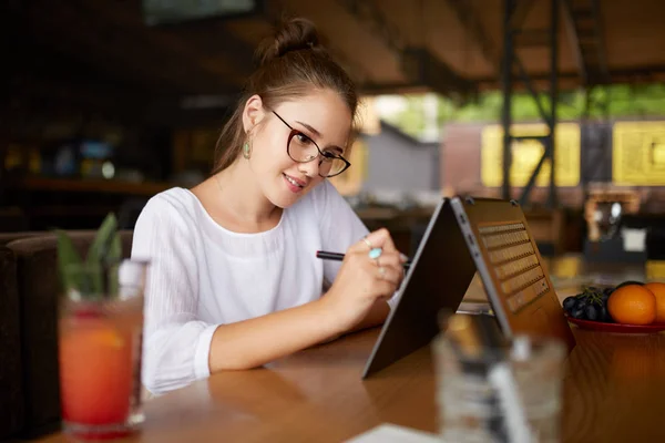 Digital artist drawing sketch with stylus on convertible 2 in 1 laptop display in tent mode. Mixed race multiethnic asian caucasian woman working on project design or writing notes on touchscreen. — Stock Photo, Image