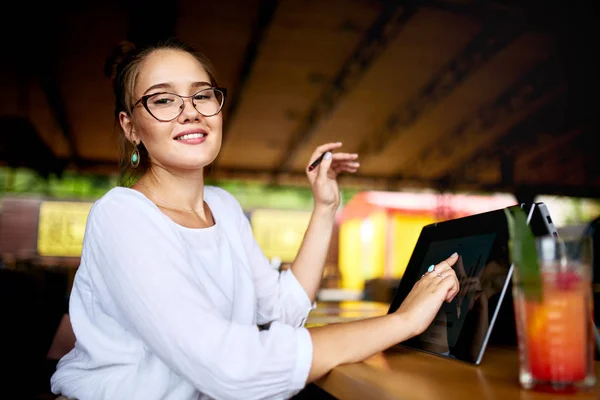 Digital artist finger touches convertible to 2 in 1 laptop display in tent mode and holds stylus. Mixed race multiethnic asian caucasian woman working on project design, writing notes on touchscreen. — Stock Photo, Image