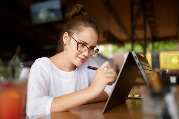 Digital artist drawing sketch with stylus on convertible 2 in 1 laptop display in tent mode. Mixed race multiethnic asian caucasian woman working on project design or writing notes on touchscreen. — Stock Photo, Image