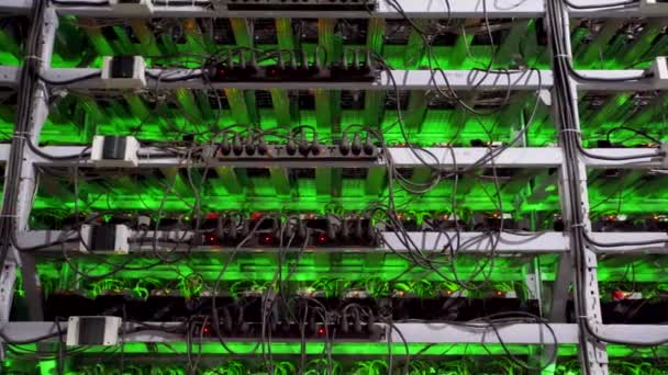 Cryptocurrency mining equipment on large farm. ASIC miners on stand racks mine bitcoin in server room. Blockchain techology application specific integrated circuit. Tripod panorama. — Stock Video