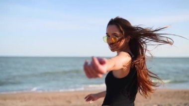 Pov, tropikal plajda erkek arkadaşı denize doğru götüren güzel kadını çekerken beni izle. Mayolu ve güneş gözlüklü oyuncu çekici kız kameraya bakıyor ve ona katılmak için çağrıda bulunuyor. Yavaş çekim.