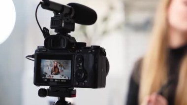Güzellik blogcusu kadın kameranın yanında günlük makyaj programını çekiyor. Etkilenen kız canlı yayın kozmetik ürünleri incelemesi yapıyor. Vlogger dişisi göz farı paleti öneriyor, master sınıfında öğretiyor..