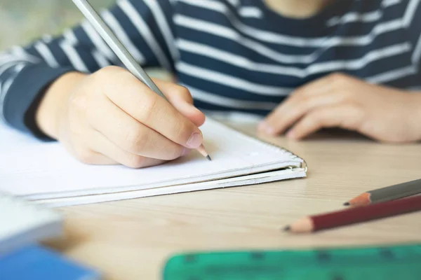 Kid writing in notebook. — Stock Photo, Image