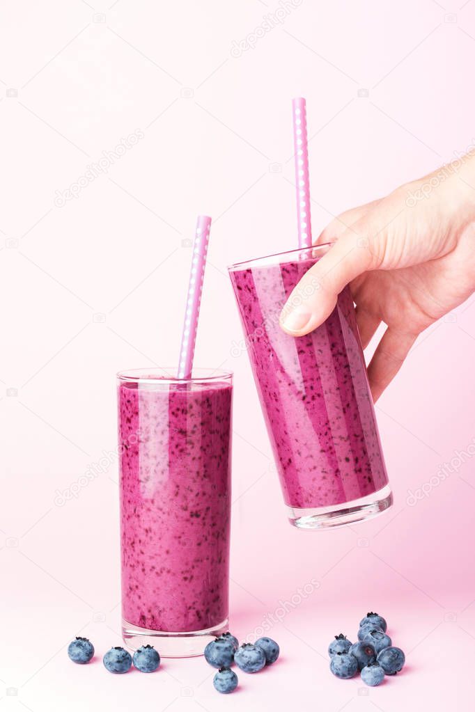 Two glasses of blueberries smoothie.