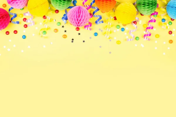 イエローの誕生日パーティーの背景 平面図です カラフルな蛇紋岩 ボールとお菓子の境界線を作った — ストック写真