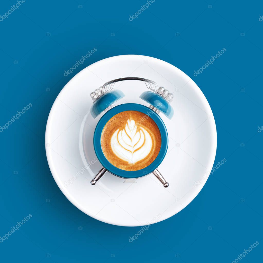 Clock with the dial of coffee on blue background.