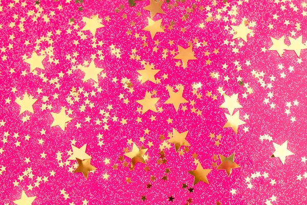 Golden star confetti on pink background.