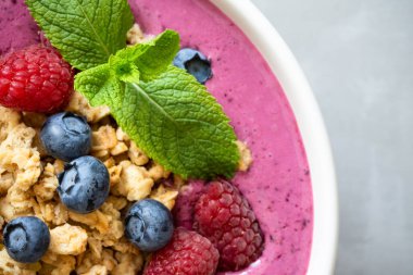 Meyveli meyve suyu kasesi ve naneli böğürtlen. Üst görünüm, kapat.