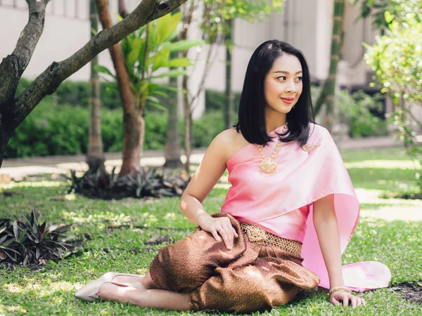 Thai woman in traditional Thai costume of ordinary Thai ancient lady in the garden.