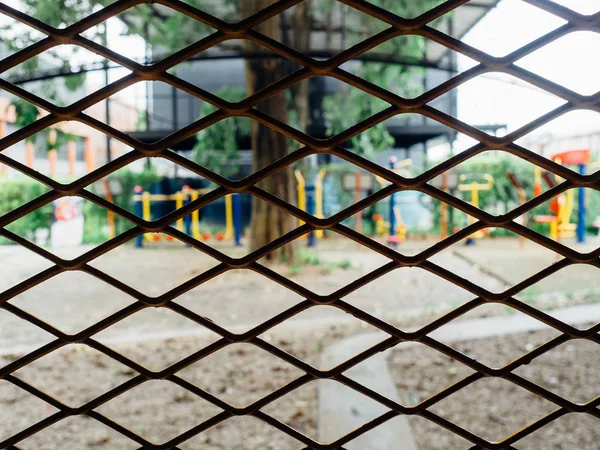 Iron fence net block the way out to the playground concept of captivity.