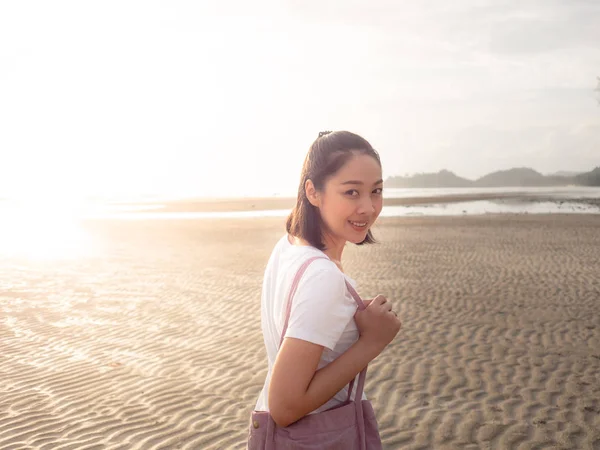 アジアの女性は日没の熱帯のビーチを歩いてください — ストック写真