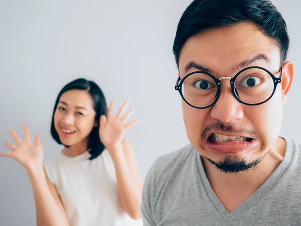 Asian angry and annoyed husband with happy and stubborn wife argument concept.