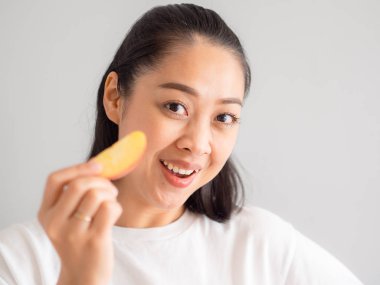 Asyalı kadın biteviye-in elma yiyor.