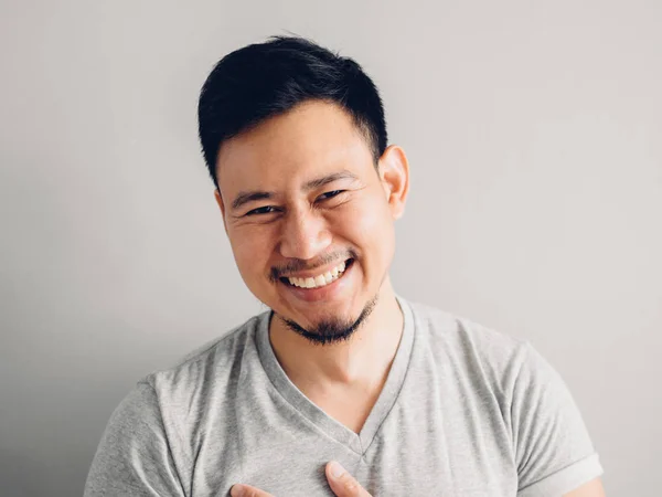 Headshot photo of Asian man with laugh face. on grey background.