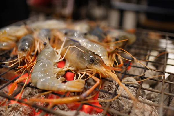 Close up of grilling seafood barbecue with charcoal stove.