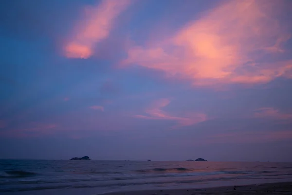 Vivid purple sky with light beam from sunset on the beach.