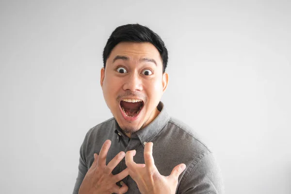 Wow and surprised face of funny good looking Asian man with hand sign pointing.