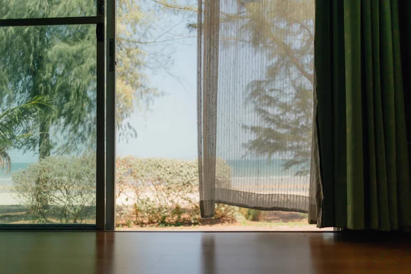 Peaceful scene of the house with white transparent curtain.