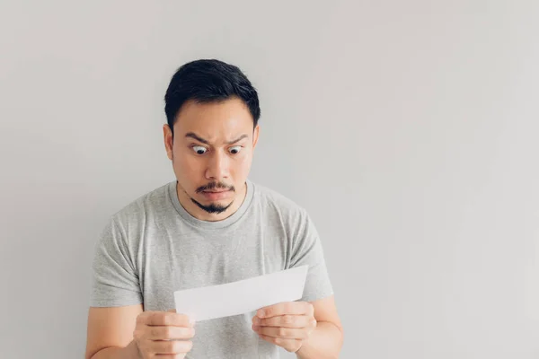 Man is shocked and surprised with the white mail message or the bill. — Stock Photo, Image