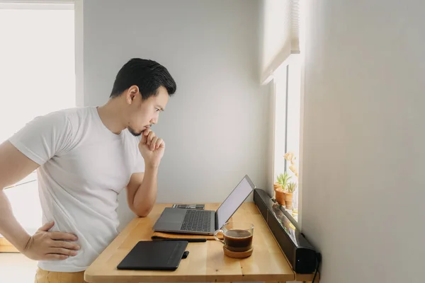Asian freelancer man is thinking and working on his laptop. Concept of freelance creative works. — Stock Photo, Image