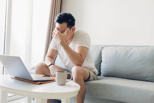 Serious man is working on his laptop in the living room. — Stock Photo, Image