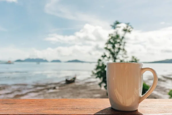 Morning coffee mug with low tide sea view. — Stock Photo, Image