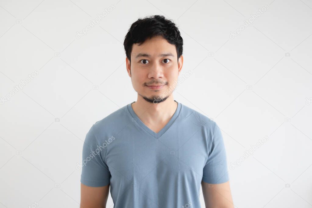 Portrait of happy man in blue t-shirt on isolated white background.