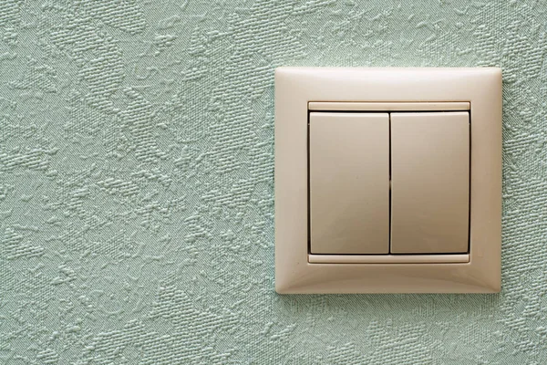 Light switch, a white plastic mechanical switch mounted on a light blue wall. Copy space — Stock Photo, Image