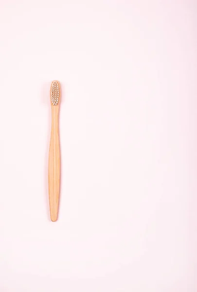 Top view of bamboo toothbrush on pastel pink background. Plastic free concept. — Stock Photo, Image
